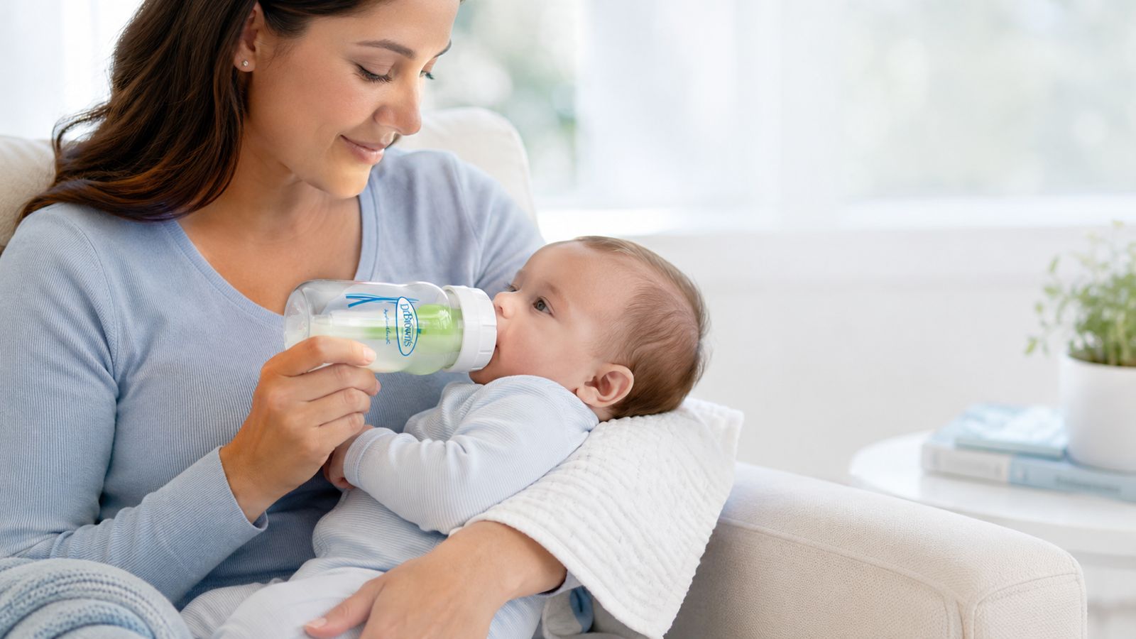Mum feeding baby with Dr Brown's bottle calmly