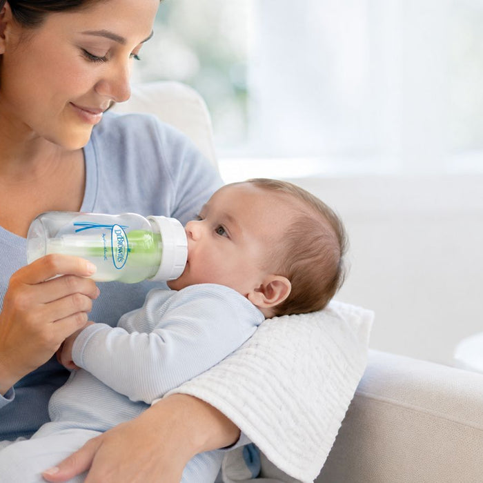 Mum feeding baby with Dr Brown's bottle calmly
